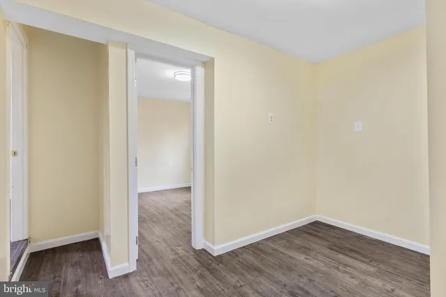 a view of a small space with wooden floor and a sink