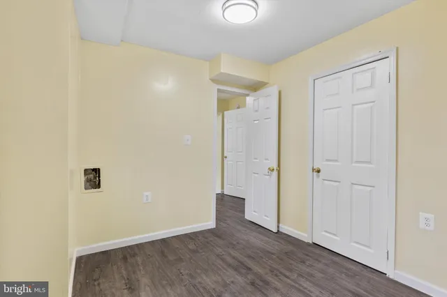 an empty room with wooden floor