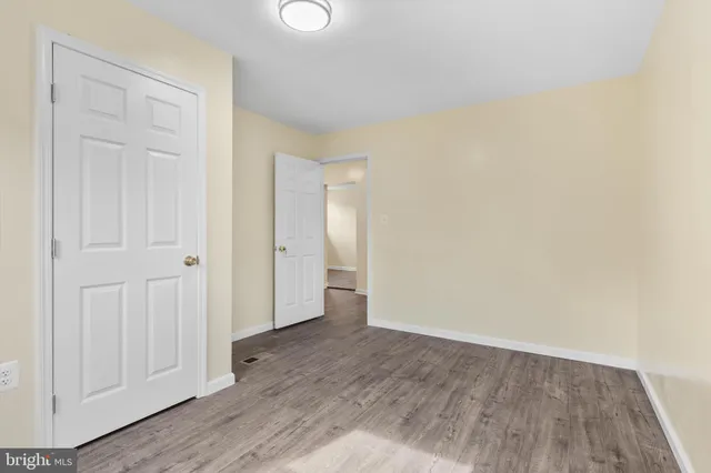 an empty room with wooden floor