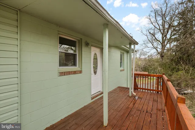 a view of backyard with wooden deck