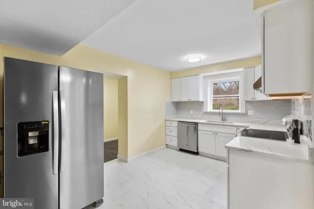 a kitchen with a refrigerator and a sink