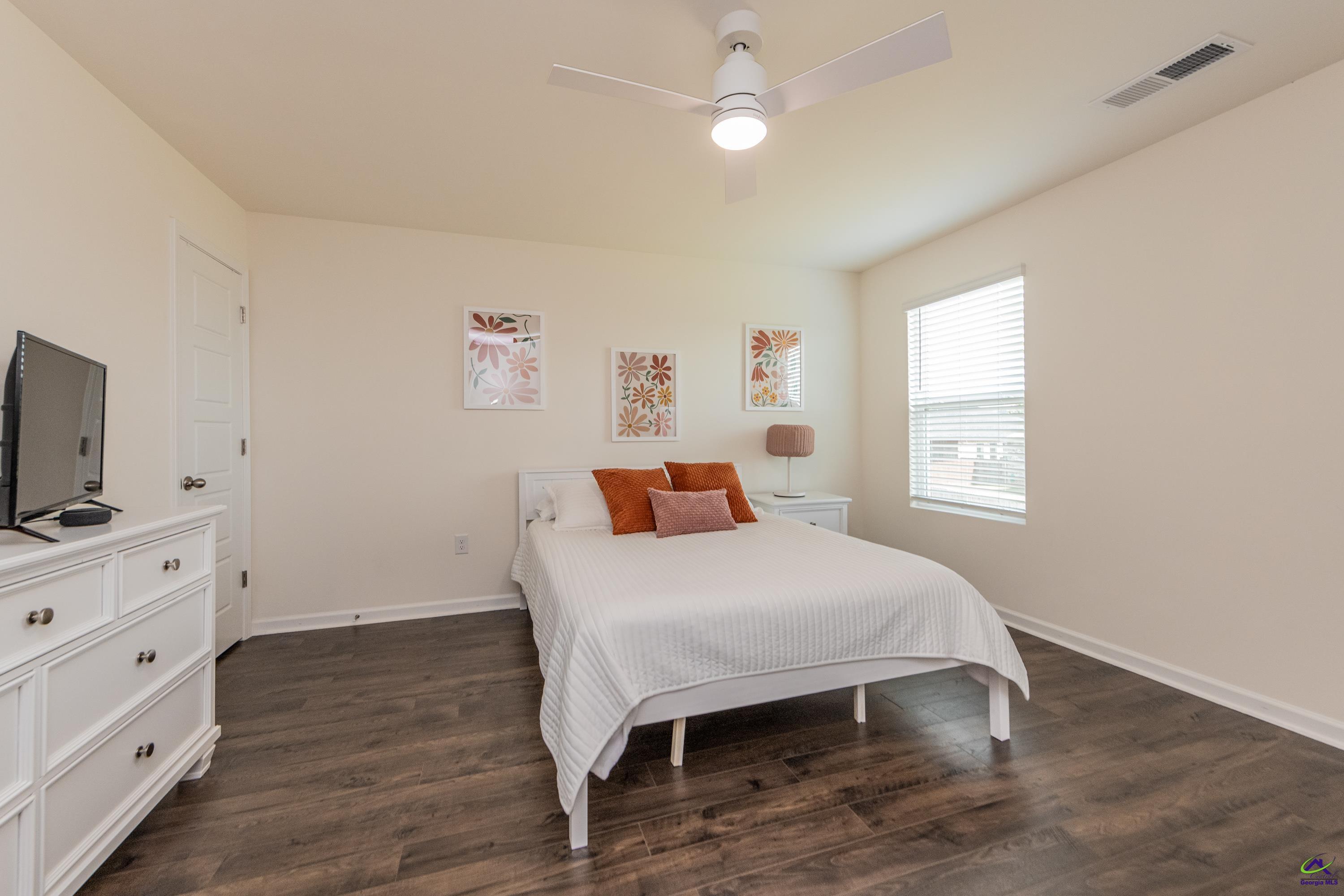 126 Farmers Way Perry, GA 31069 - Photo 21 of 39 a bedroom with a bed and a flat screen tv