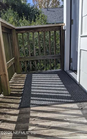 a view of a balcony with wooden floor