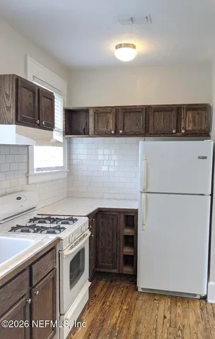 a kitchen with a stove and a microwave