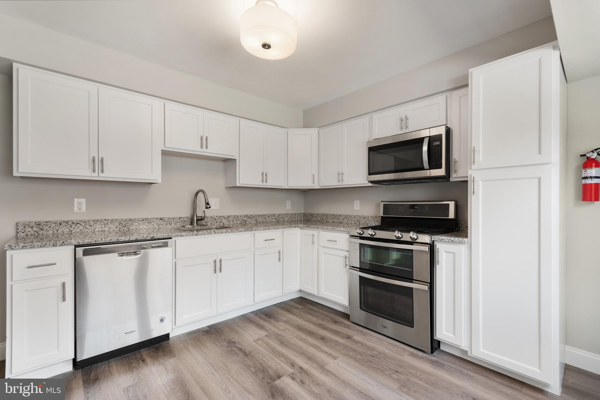 243 Jackson Road Mantua, NJ 08051 - Photo 3 of 18 a kitchen with granite countertop white cabinets stainless steel appliances and a sink