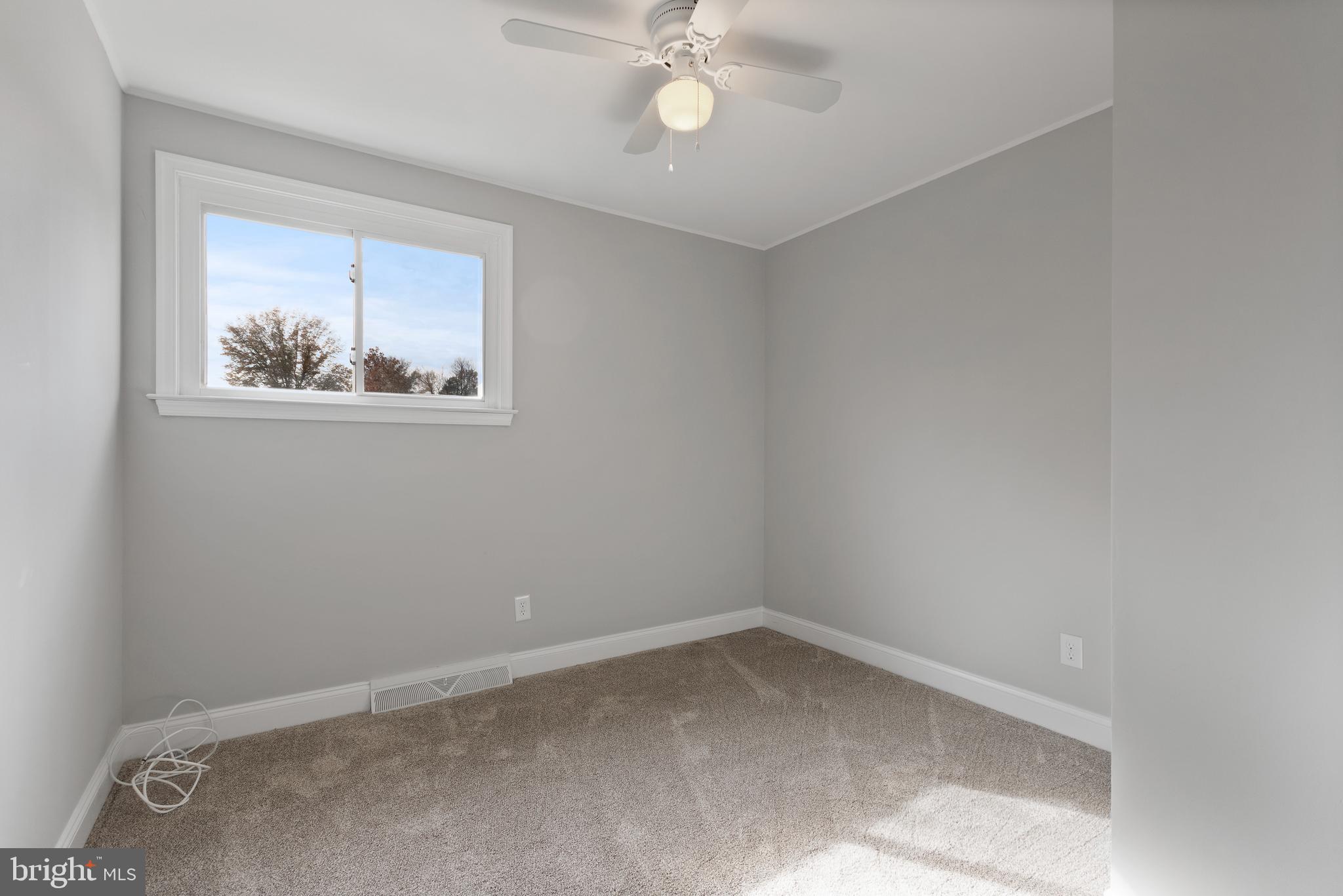 243 Jackson Road Mantua, NJ 08051 - Photo 8 of 18 an empty room with a window and a fan