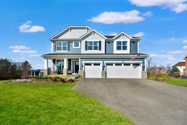 a front view of a house with a yard and garage