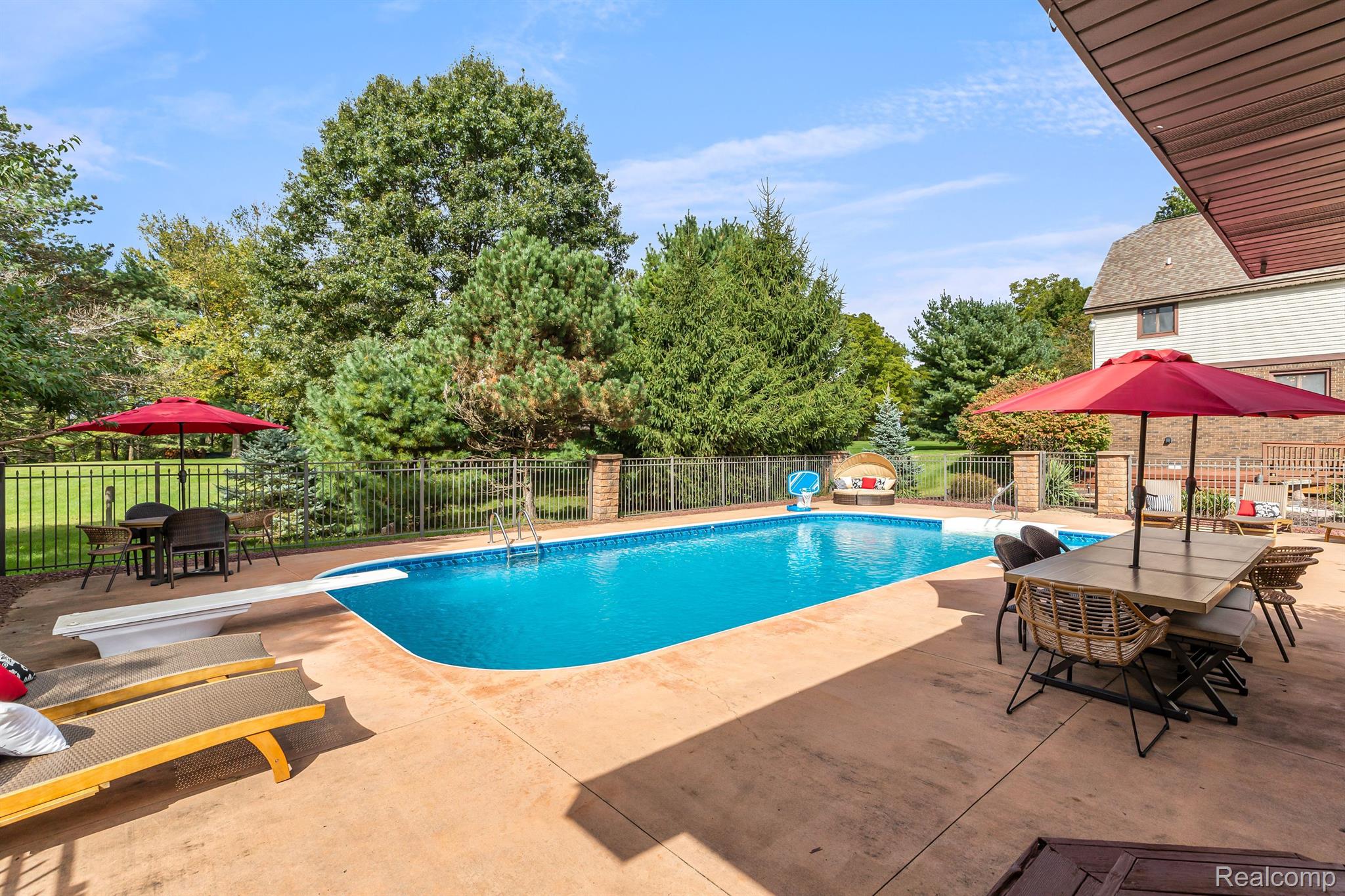 12456 Larkins Road Brighton, MI 48114 - Photo 42 of 62 Large fenced in swimming pool.