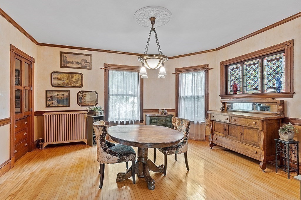 39 Maple Street Stoneham, MA 02180 - Photo 14 of 40 a dining room with furniture a chandelier and wooden floor