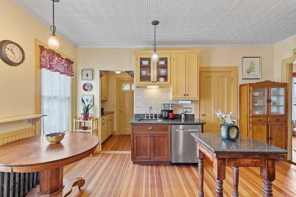 39 Maple Street Stoneham, MA 02180 - Photo 17 of 40 a kitchen with sink a refrigerator and chairs