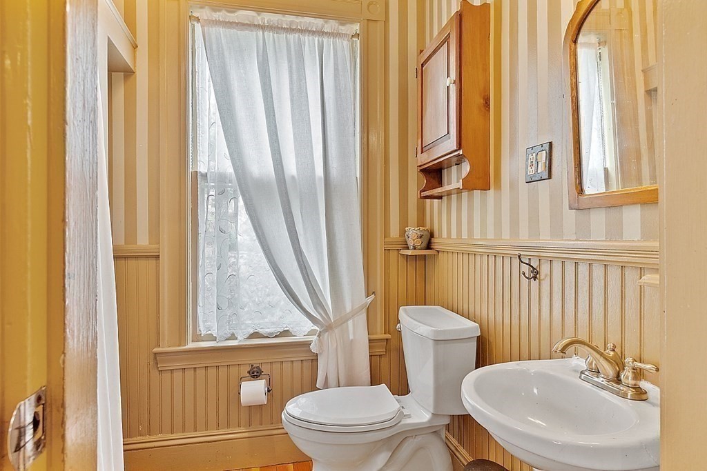 39 Maple Street Stoneham, MA 02180 - Photo 22 of 40 a bathroom with a toilet a sink and a window