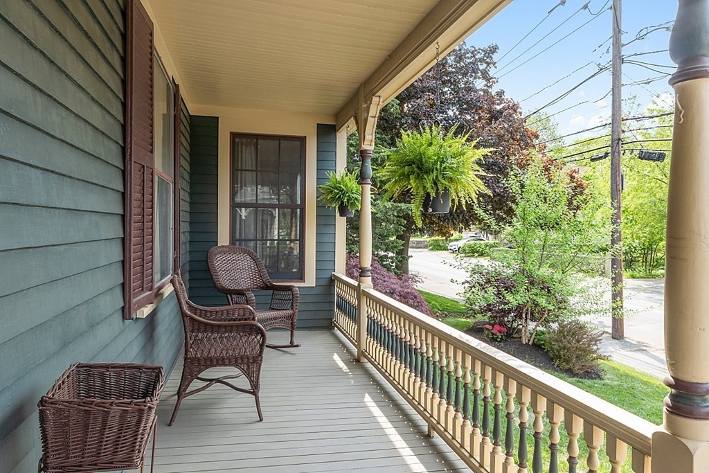 39 Maple Street Stoneham, MA 02180 - Photo 4 of 40 a view of chair in the balcony with wooden floor