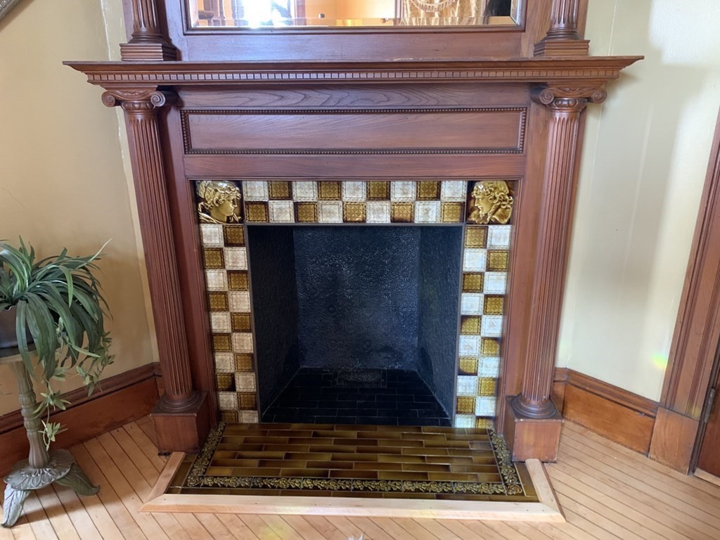 39 Maple Street Stoneham, MA 02180 - Photo 6 of 40 a view of fireplace and wooden floor