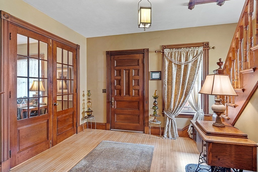 39 Maple Street Stoneham, MA 02180 - Photo 7 of 40 a view of an entryway with wooden floor and door