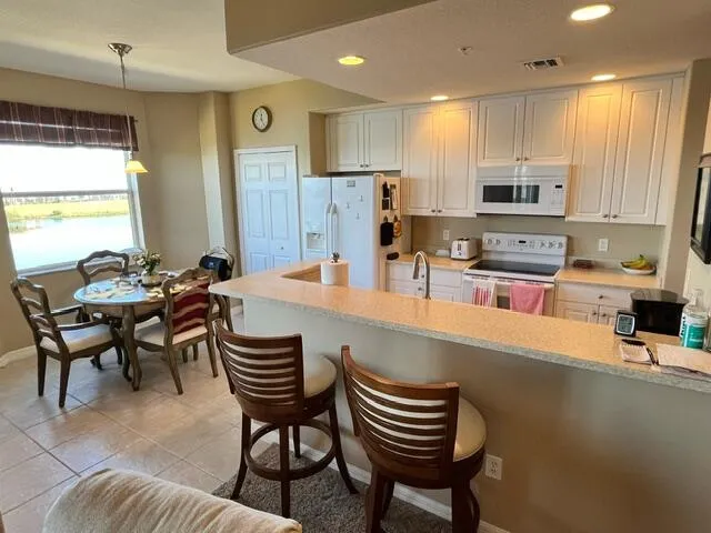 a kitchen with a dining table and chairs