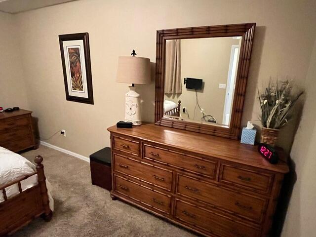 6828 Toland Drive, Unit 302 Melbourne, FL 32940 - Photo 15 of 45 a bedroom with a bed and a mirror on dresser
