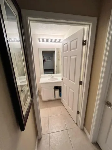 a view of a hallway with entryway and furniture