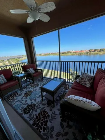 a couch sitting in a roof deck with table and chairs