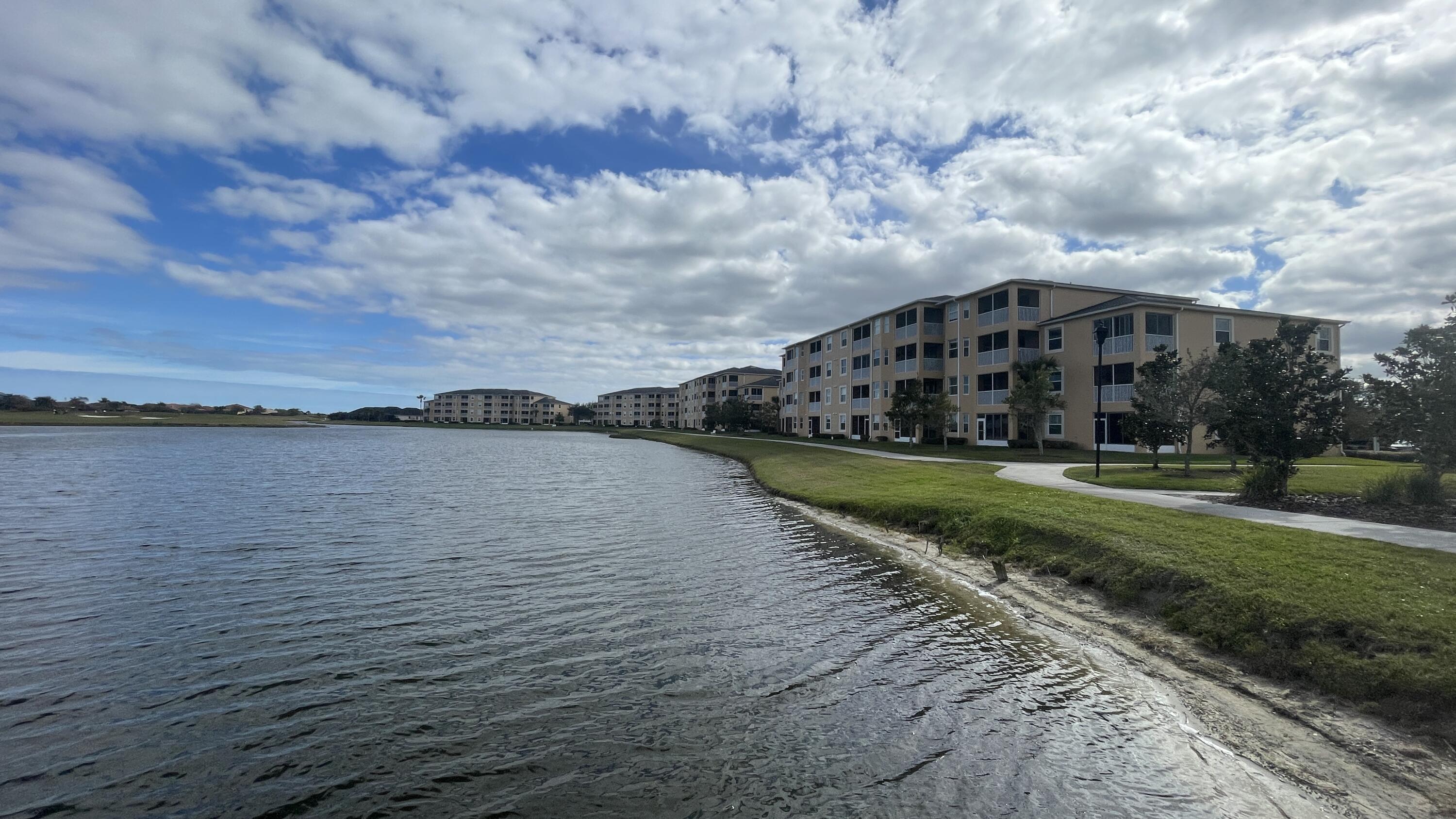 6828 Toland Drive, Unit 302 Melbourne, FL 32940 - Photo 25 of 45 a view of a fountain in front of a lake