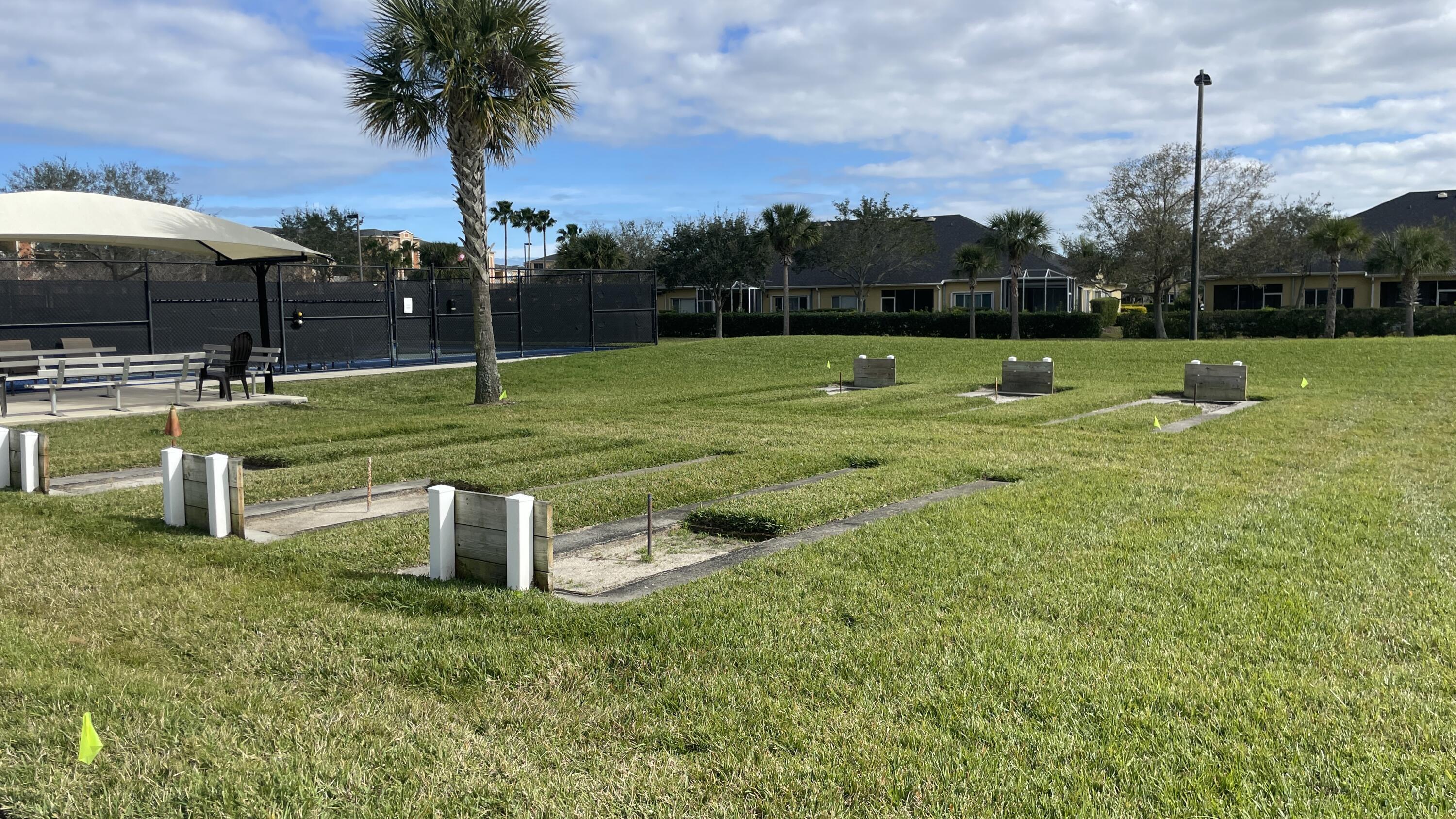 6828 Toland Drive, Unit 302 Melbourne, FL 32940 - Photo 31 of 45 a view of a fountain in front of a house with a yard
