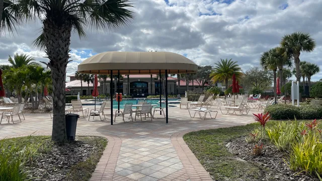 a view of a house with backyard and sitting area