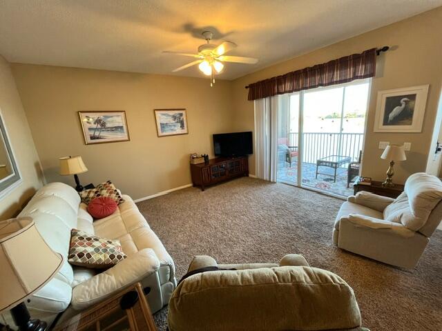 6828 Toland Drive, Unit 302 Melbourne, FL 32940 - Photo 7 of 45 a living room with furniture and a flat screen tv