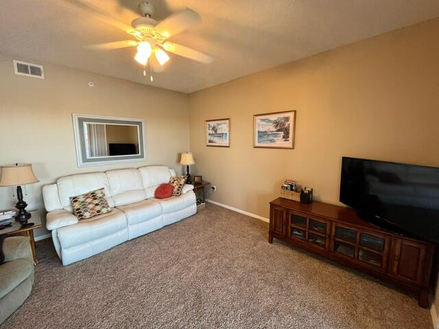 6828 Toland Drive, Unit 302 Melbourne, FL 32940 - Photo 8 of 45 a living room with furniture and a flat screen tv
