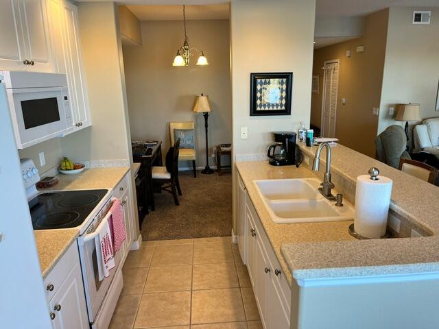 6828 Toland Drive, Unit 302 Melbourne, FL 32940 - Photo 10 of 45 a kitchen with a sink and a stove top oven