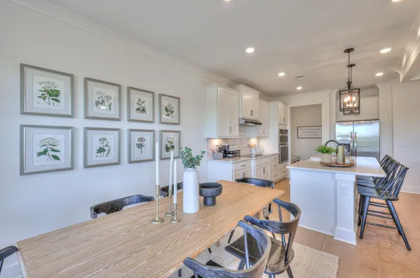 a view of a hallway with wooden floor and windows