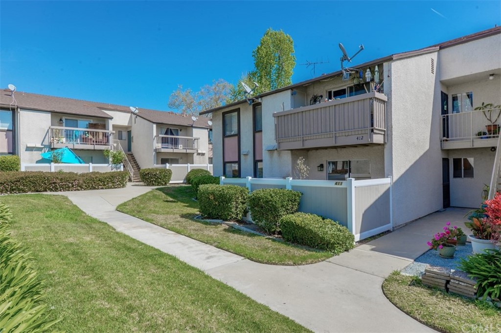 8990 19th Street, Unit 411 Rancho Cucamonga, CA 91701 - Photo 1 of 1 a front view of a house with a yard