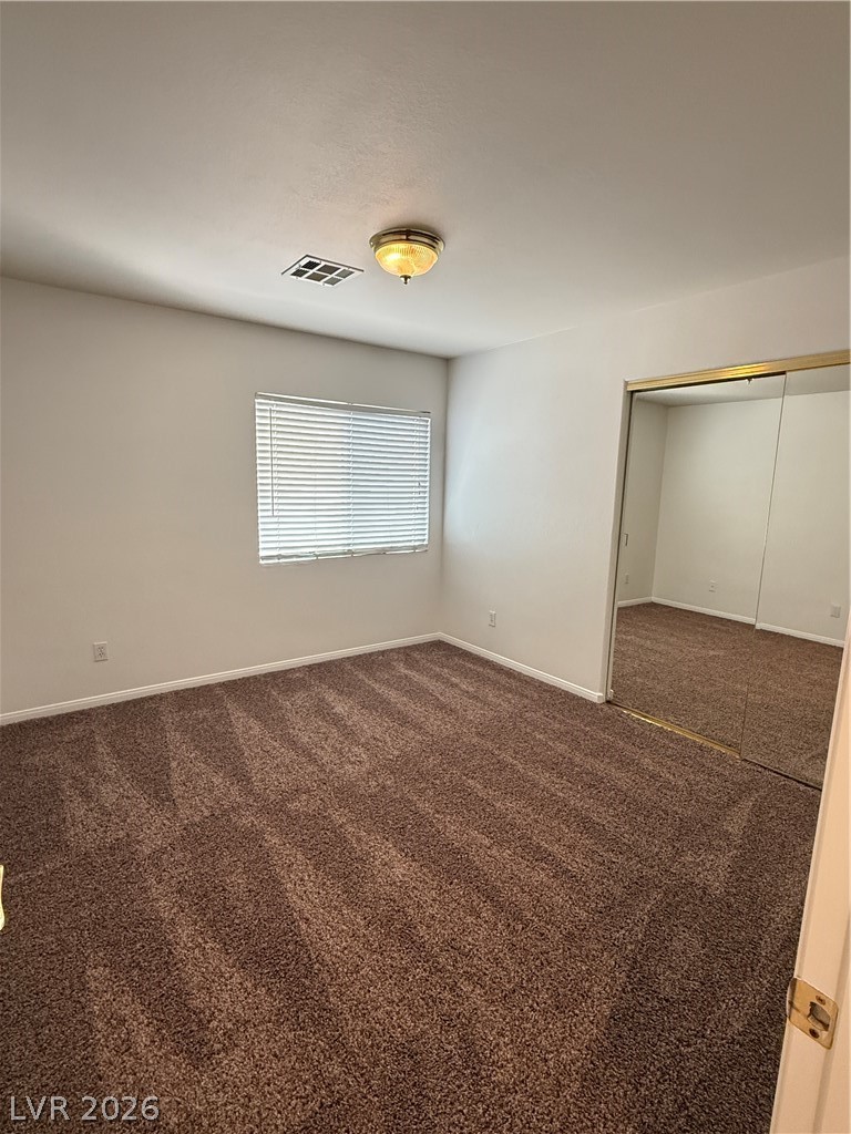 10975 Calcedonian Street Las Vegas, NV 89141 - Photo 14 of 25 This cozy bedroom features plush carpeting and a bright window, creating a comfortable living space.