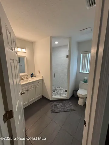 a bathroom with a toilet and a shower