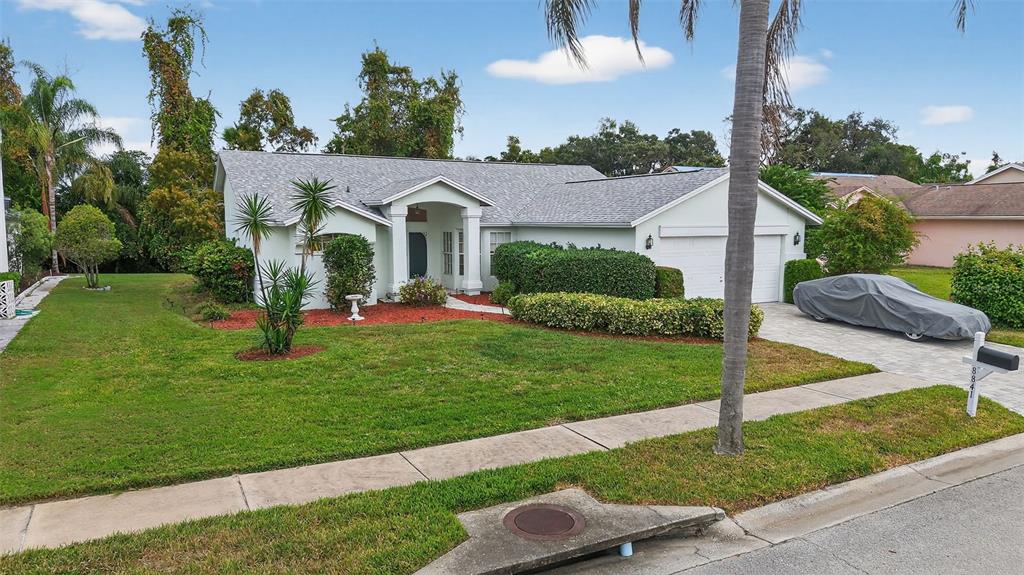8841 Kipling Avenue Hudson, FL 34667 - Photo 3 of 41 a front view of a house with a yard