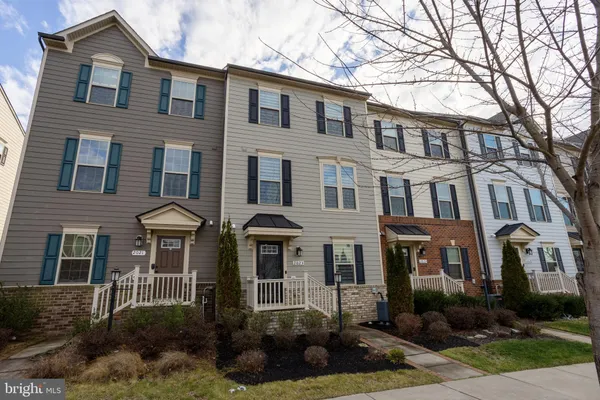 a front view of a residential apartment building with a yard