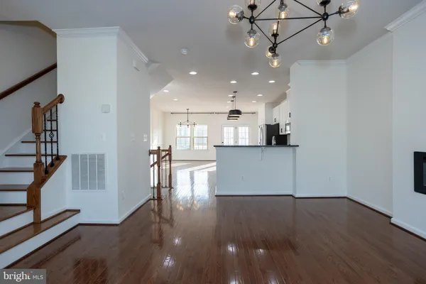 a view of a kitchen with a sink wooden floor and a kitchen