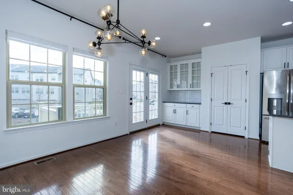 a kitchen with stainless steel appliances granite countertop a refrigerator a stove a sink and a microwave