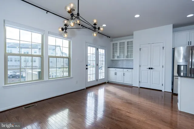 a kitchen with stainless steel appliances granite countertop a refrigerator a stove a sink and a microwave