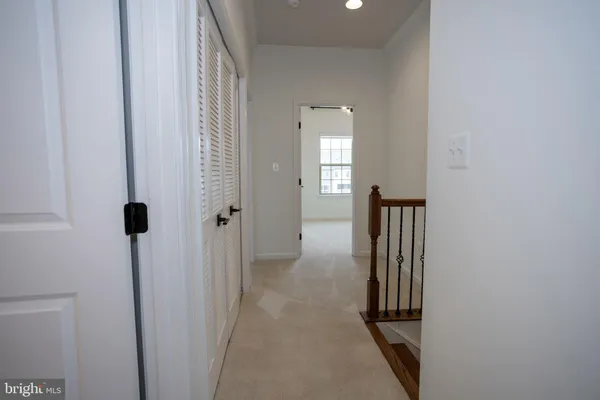 a view of a hallway with wooden floor and entryway