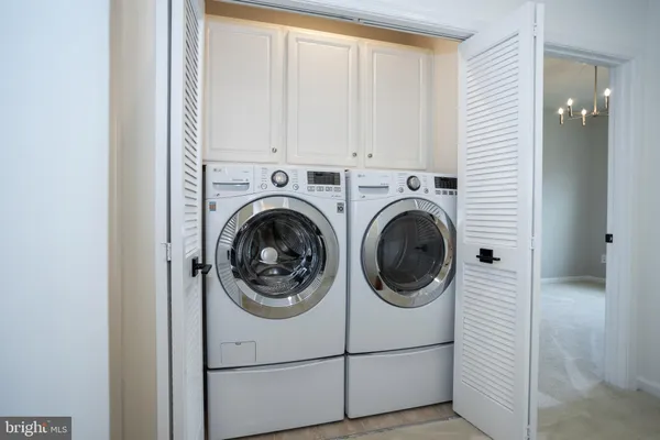 a view of a chandelier in big room and chandelier
