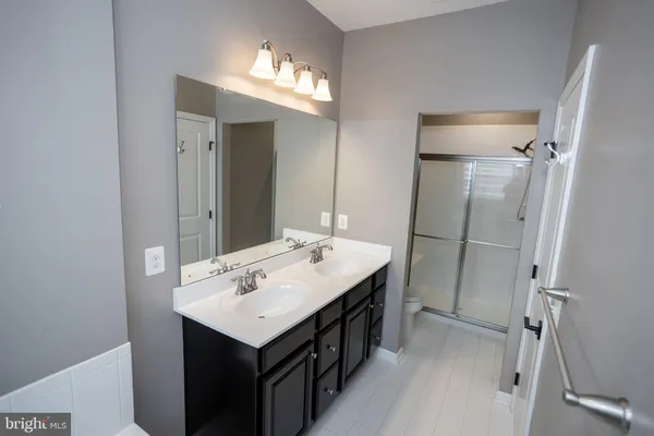a bathroom with a tub sink and mirror