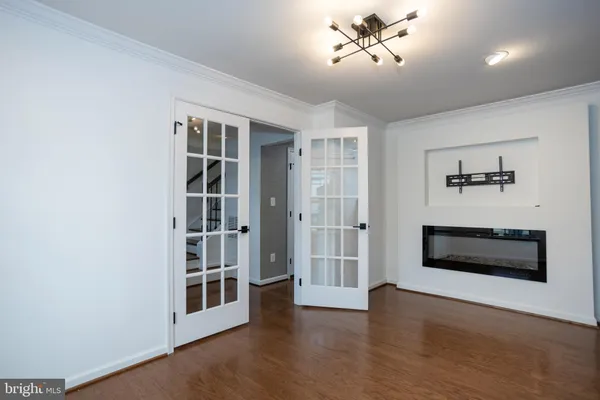 a view of an empty room with a fireplace and a window