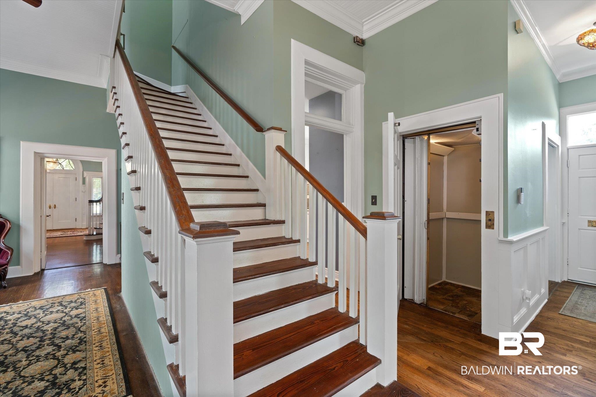 1953 Dauphin Street Mobile, AL 36606 - Photo 17 of 56 Stairs featuring a high ceiling, hardwood / wood-style flooring, and ornamental molding