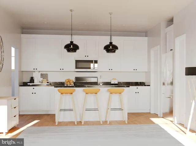 a kitchen with stainless steel appliances granite countertop a sink a stove a refrigerator and white cabinets