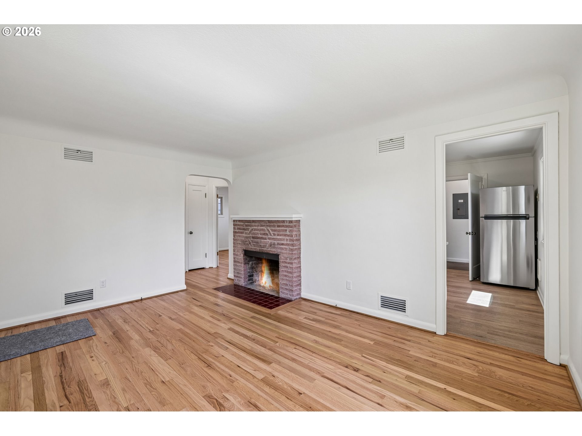 536 28th Avenue Longview, WA 98632 - Photo 7 of 26 a view of empty room with wooden floor and fireplace