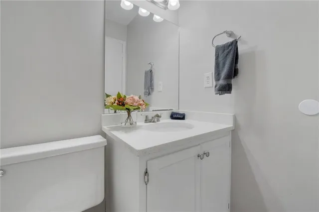 a bathroom with a sink vanity and a mirror
