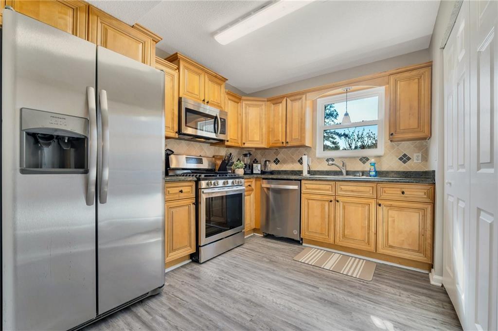 Undisclosed Address Marietta, GA 30064 - Photo 12 of 25 a kitchen with stainless steel appliances a refrigerator sink and microwave