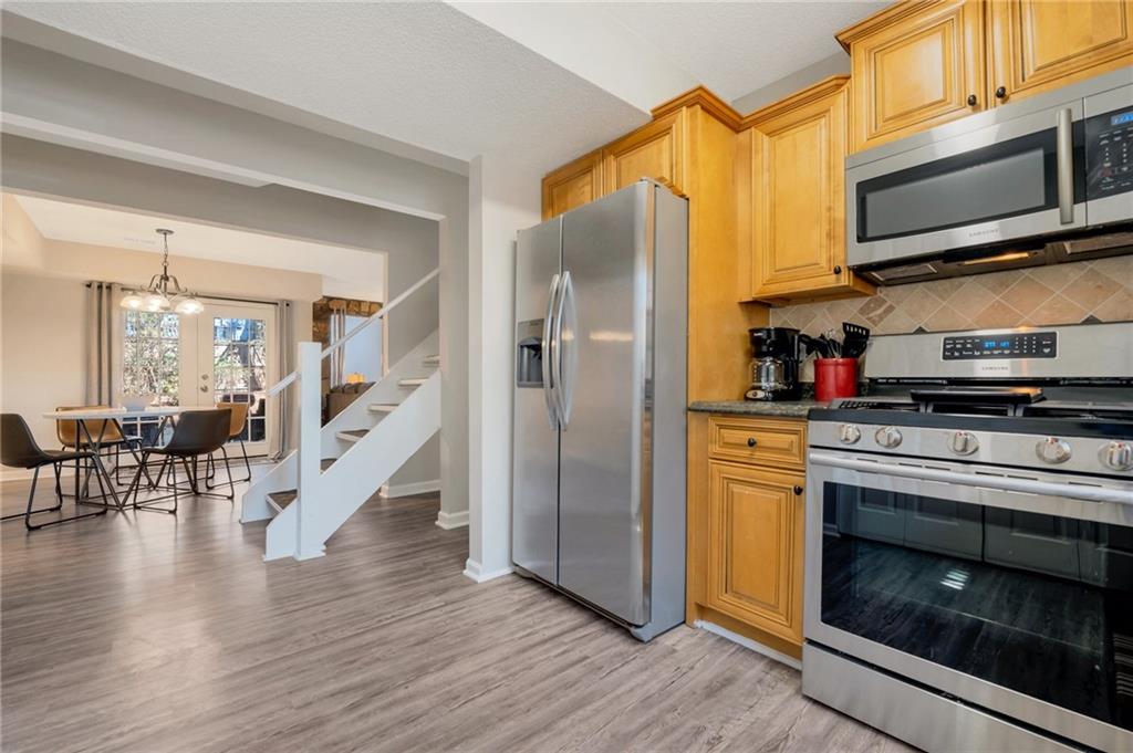 Undisclosed Address Marietta, GA 30064 - Photo 14 of 25 a kitchen with stainless steel appliances granite countertop a refrigerator microwave and stove top oven