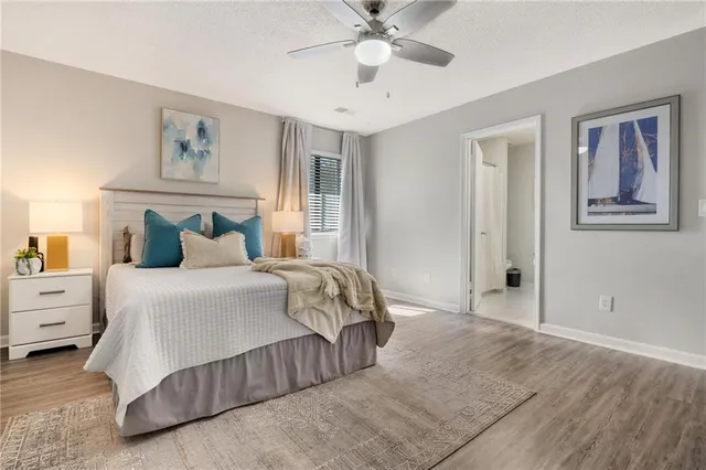 a bedroom with a large bed and a chandelier