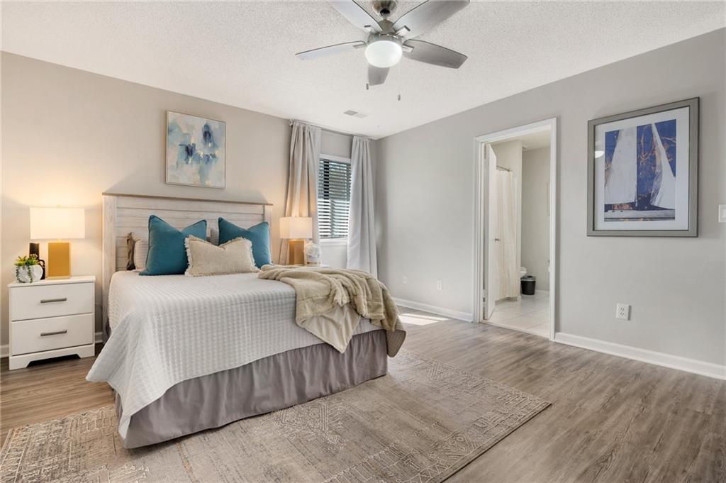 Undisclosed Address Marietta, GA 30064 - Photo 17 of 25 a bedroom with a large bed and a chandelier