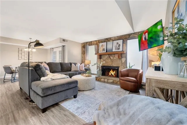 a living room with furniture a fireplace and a flat screen tv